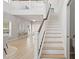 Bright foyer with beautiful staircase, wood floors, and elegant decor creates an inviting entrance to the home at 5360 Riverwalk Preserve Dr, New Port Richey, FL 34653