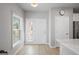 Bright foyer featuring wood-look floors, white trim, and a door to the outside at 5360 Riverwalk Preserve Dr, New Port Richey, FL 34653