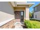 Inviting front entrance with a decorative wreath, stone accents, and manicured shrubs at 5360 Riverwalk Preserve Dr, New Port Richey, FL 34653