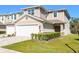 Charming two-story townhome featuring an attached garage, neutral color palette, and well-maintained landscaping at 5360 Riverwalk Preserve Dr, New Port Richey, FL 34653