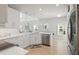 Bright kitchen showcasing white cabinets, stainless steel appliances, and a corner sink with natural light at 5360 Riverwalk Preserve Dr, New Port Richey, FL 34653