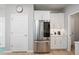 Sleek, updated kitchen with stainless steel refrigerator and white cabinetry, offering a modern aesthetic at 5360 Riverwalk Preserve Dr, New Port Richey, FL 34653