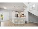 Modern kitchen with white cabinets, stainless steel appliances, and a breakfast bar with stylish pendant lighting at 5360 Riverwalk Preserve Dr, New Port Richey, FL 34653