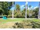 Comfortable blue lawn chairs provide a relaxing spot to enjoy the serene view of the pond and natural surroundings at 5360 Riverwalk Preserve Dr, New Port Richey, FL 34653