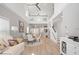 Bright open-concept living space featuring a dining area, modern staircase, and high ceilings with loft access at 5360 Riverwalk Preserve Dr, New Port Richey, FL 34653