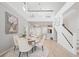 Inviting living space featuring a dining area, staircase, and views to the second floor loft area at 5360 Riverwalk Preserve Dr, New Port Richey, FL 34653
