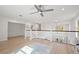 Open loft area with wooden banister, recessed lighting, ceiling fan, and wood flooring at 5360 Riverwalk Preserve Dr, New Port Richey, FL 34653