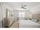 Bright main bedroom with decorative furniture, wood floors, ceiling fan, and lots of natural light at 5360 Riverwalk Preserve Dr, New Port Richey, FL 34653