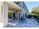 Covered patio featuring outdoor seating and tiled flooring in a backyard setting at 5360 Riverwalk Preserve Dr, New Port Richey, FL 34653