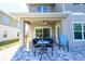 Outdoor patio showcases tiled flooring, a covered seating area, and backyard views at 5360 Riverwalk Preserve Dr, New Port Richey, FL 34653