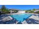 Community pool with a lounging area offers a relaxing recreational space for residents at 5360 Riverwalk Preserve Dr, New Port Richey, FL 34653