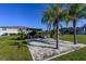 Sand volleyball court surrounded by trees and landscaping with nearby residential buildings at 5360 Riverwalk Preserve Dr, New Port Richey, FL 34653