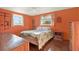 Bright bedroom with hardwood floors and a large window at 5523 Cheyenne Dr, Holiday, FL 34690