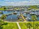Aerial view of a marina with docks, boats, and well-maintained residential buildings and landscaping at 5557 Sea Forest Dr # 318, New Port Richey, FL 34652