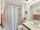 Clean bathroom featuring a shower with glass door, white vanity, and neutral decor at 5557 Sea Forest Dr # 318, New Port Richey, FL 34652