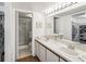 Spacious bathroom featuring double sinks, walk-in shower, and ample storage at 5557 Sea Forest Dr # 318, New Port Richey, FL 34652