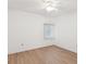 Unfurnished bedroom with a ceiling fan, light colored hardwood flooring, and natural light from a window at 5557 Sea Forest Dr # 318, New Port Richey, FL 34652