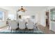 Dining room featuring a large table with seating for eight, fan and views into the kitchen at 5557 Sea Forest Dr # 318, New Port Richey, FL 34652