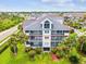 Beautiful three-story condo building with lush landscaping and screened balconies in a tropical setting at 5557 Sea Forest Dr # 318, New Port Richey, FL 34652