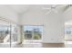 Bright and spacious living room with wood floors, ceiling fan, and sliding glass doors leading to an outdoor balcony at 5557 Sea Forest Dr # 318, New Port Richey, FL 34652