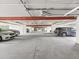 Well lit concrete parking garage with painted ceilings and clearly marked parking spaces at 5557 Sea Forest Dr # 318, New Port Richey, FL 34652