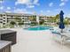 Beautiful community pool with plenty of lounge chairs, tables with umbrellas, and shade for residents at 5557 Sea Forest Dr # 318, New Port Richey, FL 34652