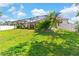 Expansive backyard featuring a screened-in lanai and manicured landscaping at 5737 Wynstone Ln, Zephyrhills, FL 33541