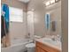 Standard bathroom with a shower-tub combo, toilet, and wooden vanity with sink at 5737 Wynstone Ln, Zephyrhills, FL 33541