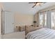 Bedroom with ceiling fan, carpet, and ample natural light from the window at 5737 Wynstone Ln, Zephyrhills, FL 33541