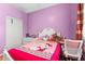 Cute bedroom with pink walls, white furniture, and Hello Kitty themed decorations at 5737 Wynstone Ln, Zephyrhills, FL 33541
