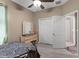 Neutral bedroom featuring a ceiling fan, closet, and a view to the bathroom at 5737 Wynstone Ln, Zephyrhills, FL 33541