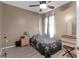 Cozy bedroom with ceiling fan, soft natural light, neutral walls, and modern flooring at 5737 Wynstone Ln, Zephyrhills, FL 33541