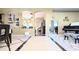 Elegant entryway with tile flooring leads to a dining area and another room, showcasing the home's open layout at 5737 Wynstone Ln, Zephyrhills, FL 33541