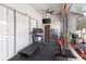 Home gym featuring a treadmill, ceiling fan, a clock, a mirror and rubber flooring at 5737 Wynstone Ln, Zephyrhills, FL 33541