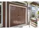 Double front entry doors beneath a window transom and 'Welcome' sign, with shelving at 5737 Wynstone Ln, Zephyrhills, FL 33541