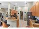 Open concept kitchen with granite countertops, stainless appliances, tile flooring, and breakfast bar at 5737 Wynstone Ln, Zephyrhills, FL 33541