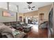 Bright living room featuring hardwood floors, a large sectional sofa, and sliding glass doors to the pool at 5737 Wynstone Ln, Zephyrhills, FL 33541