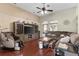 Spacious living room with hardwood floors, large television, massage chair, and cozy sectional sofa at 5737 Wynstone Ln, Zephyrhills, FL 33541