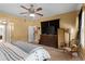 Main bedroom featuring a ceiling fan, neutral-toned walls and wood-look flooring at 5737 Wynstone Ln, Zephyrhills, FL 33541