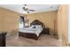 Spacious main bedroom with ceiling fan, neutral-toned walls and wood-look flooring at 5737 Wynstone Ln, Zephyrhills, FL 33541