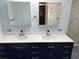 Bathroom with dual sinks, blue cabinets and quartz countertop provide function and style at 5956 Seaside Dr, New Port Richey, FL 34652