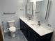 Well-lit bathroom featuring a double sink vanity, modern fixtures, and a toilet with comfort features at 5956 Seaside Dr, New Port Richey, FL 34652
