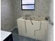 Bathroom with walk-in tub and tiled walls. Large window provides light and ventilation at 5956 Seaside Dr, New Port Richey, FL 34652