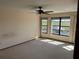 Bright bedroom features a ceiling fan and large windows overlooking the neighborhood at 5956 Seaside Dr, New Port Richey, FL 34652