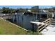 Dock with boat lift, power boats, and waterfront views of the adjacent residential high rise buildings at 5956 Seaside Dr, New Port Richey, FL 34652