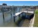 Modern boat lift with wood dock and waterfront views; great for boaters and water enthusiasts at 5956 Seaside Dr, New Port Richey, FL 34652