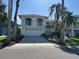 Two-story home featuring a 2-car garage, arched balconies and well manicured landscaping at 5956 Seaside Dr, New Port Richey, FL 34652