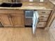 Kitchen with beautiful granite counters, stainless steel ice maker, and natural wood cabinets and drawers at 5956 Seaside Dr, New Port Richey, FL 34652