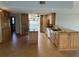 Bright kitchen featuring an island, granite countertops, wood cabinets and mosaic backsplash at 5956 Seaside Dr, New Port Richey, FL 34652