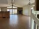 Spacious living room showcasing wood-look tile floors, stone fireplace, and sliding glass doors at 5956 Seaside Dr, New Port Richey, FL 34652